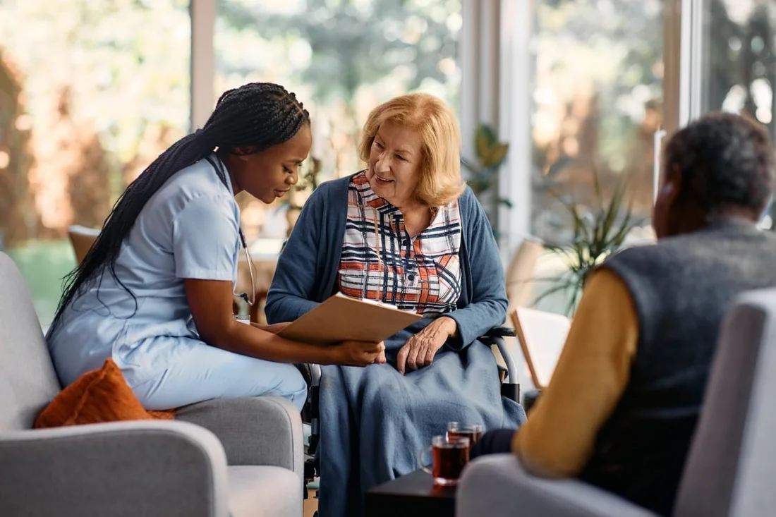 A caregiver reviewing information with an older woman, from Horizon’s website
